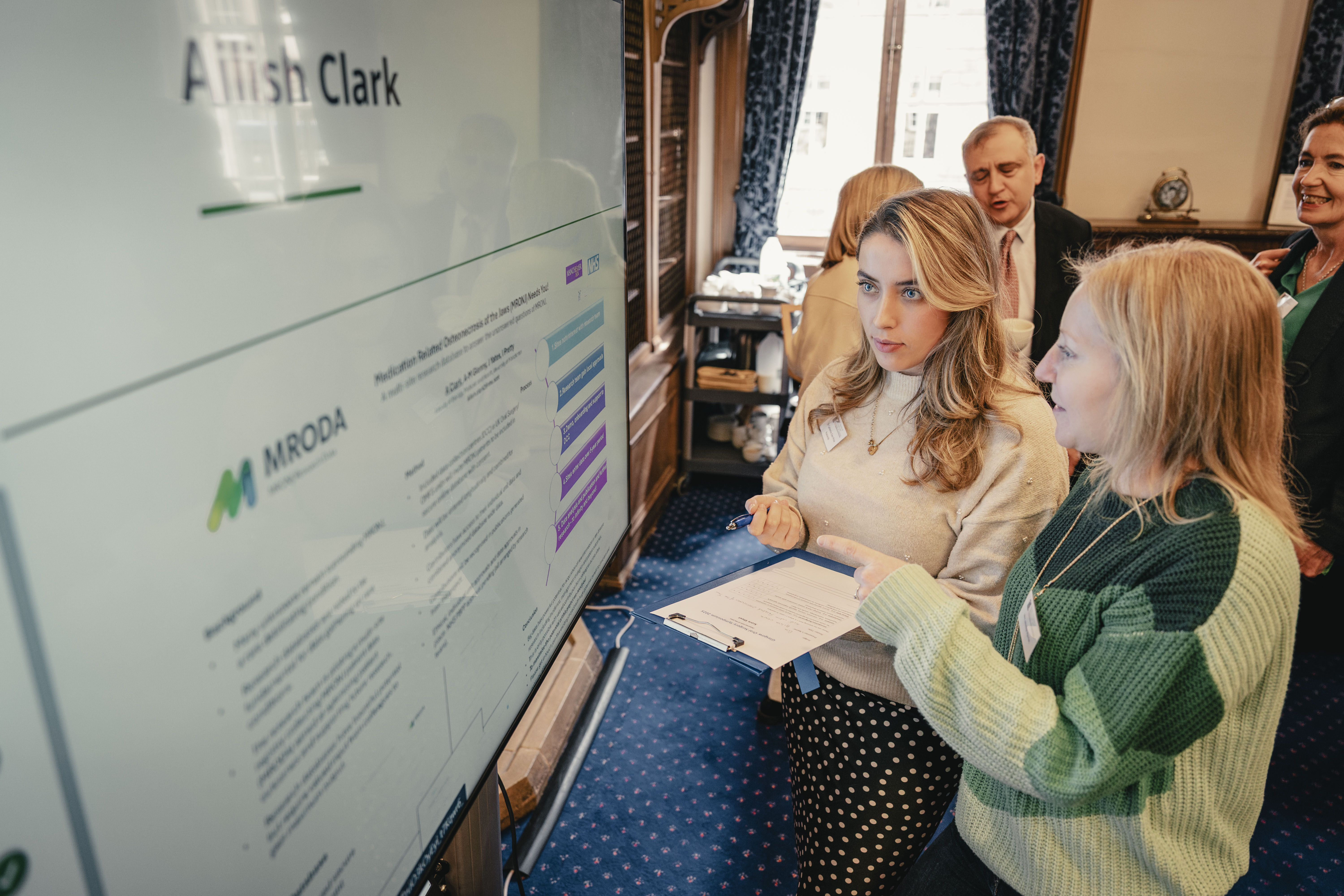 two people looking at a poster competition submission